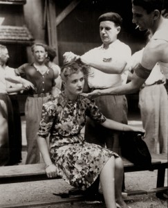 A French woman has her head shaved by civilians as a penalty for having consorted with German troops, 1944